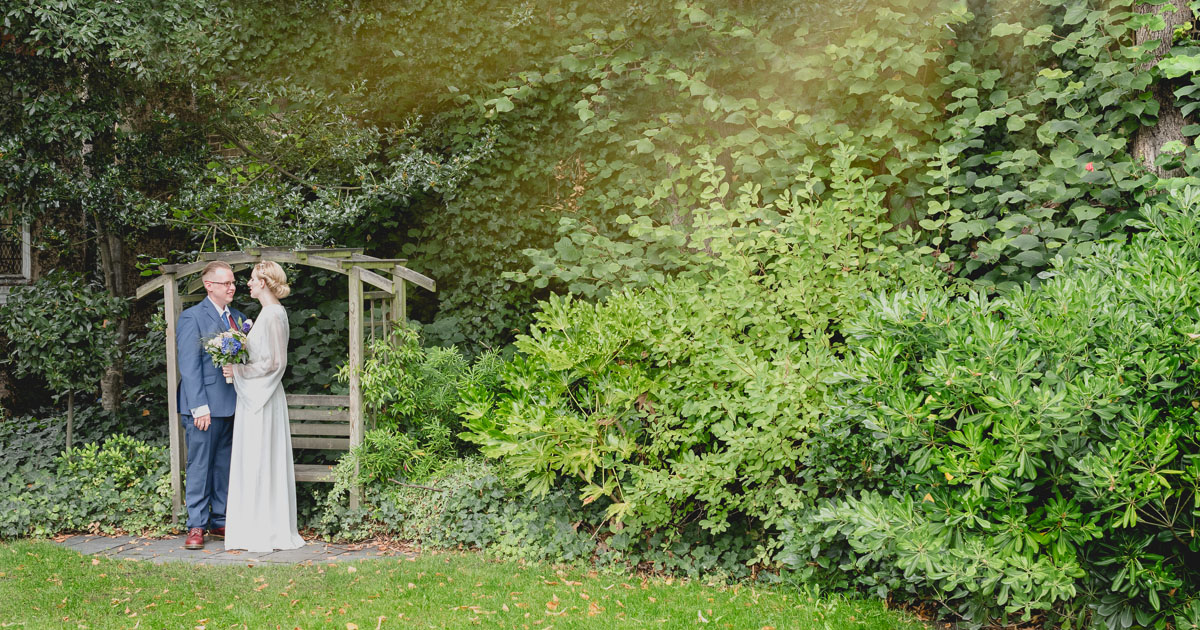 Bride and groom in the garden of city wedding venue by Wilson and Lewis Photography