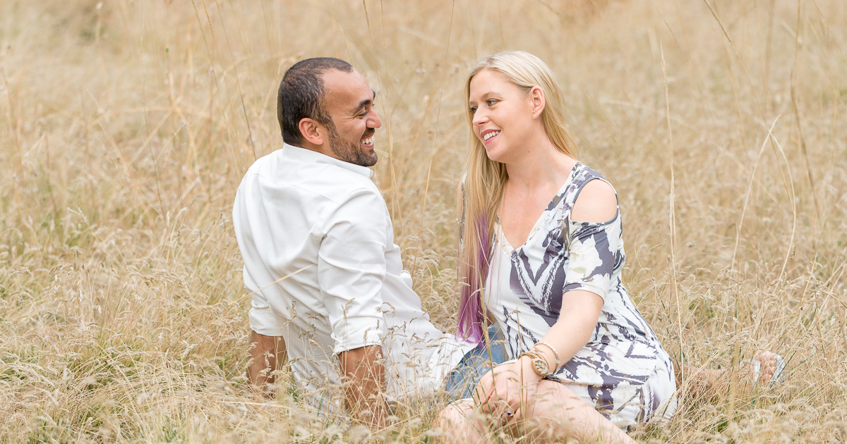 engagement photography - couple seated in grass