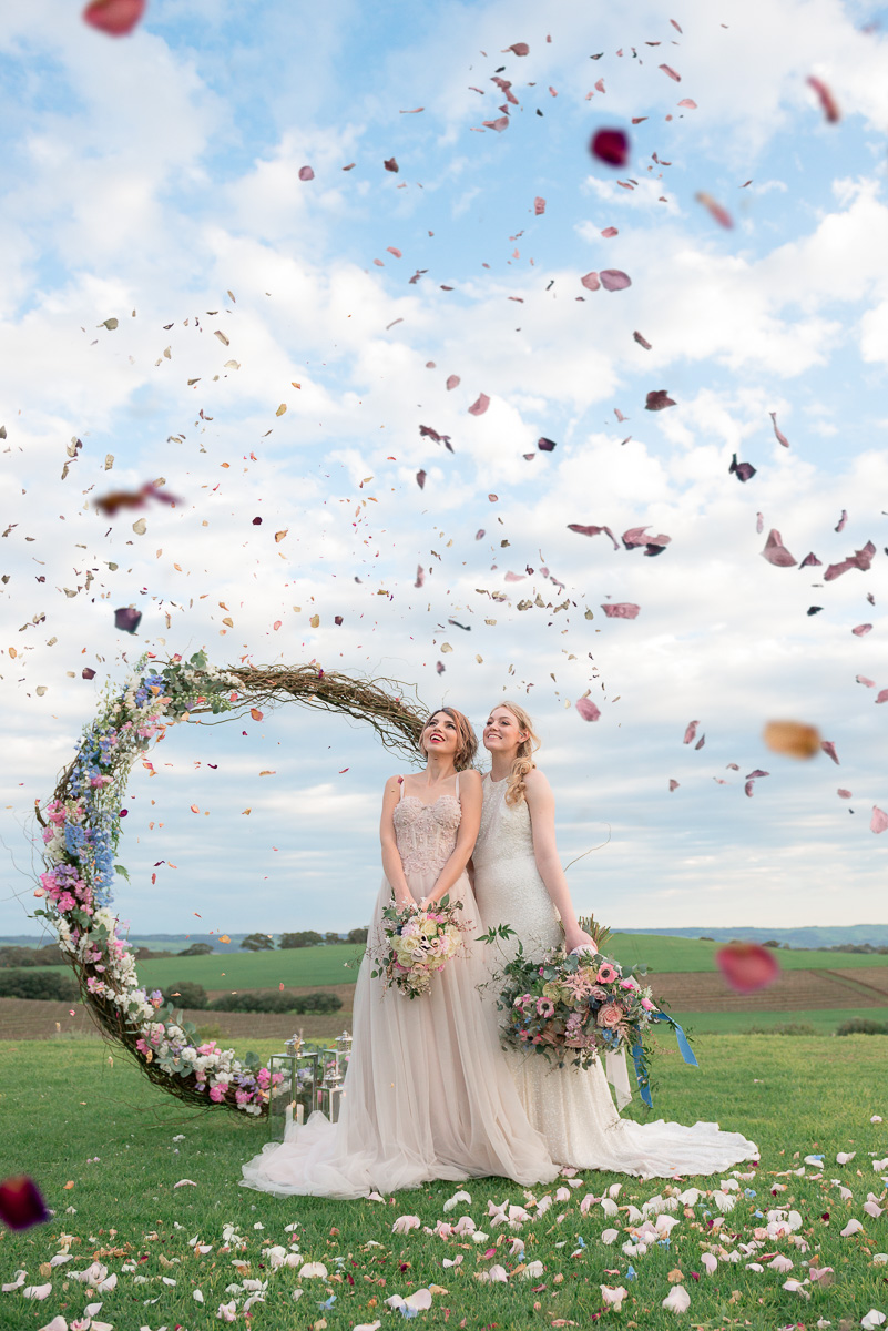 petals fly through the air at same sex wedding