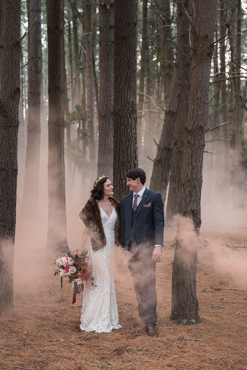 wedding photo of bride and groom in smokey forest