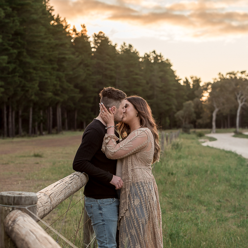 Kissing during engagement photograly session at mclaren vale