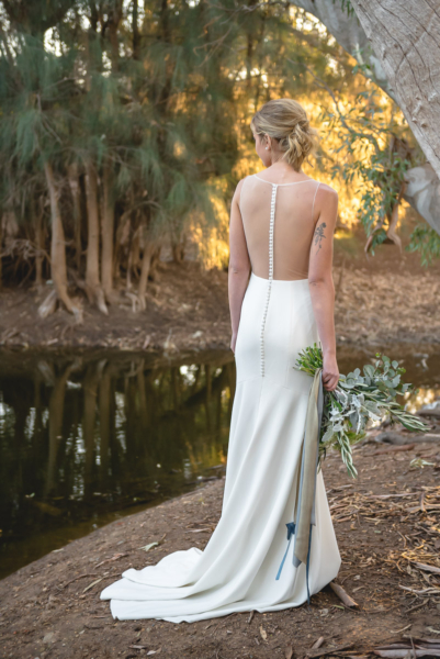 Bride looking at lake in McLaren Vale - dress Lotus by Theia Couture, courtesy of The Bride Lab