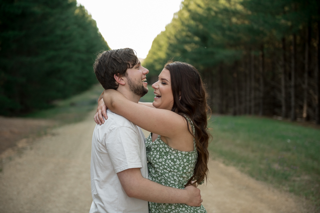 lovers laughing in forest by Adelaide engagement photographer Wilson and Lewis Photography