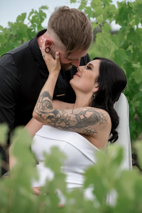 bride with tattoo kisses husband in vines by Adelaide Wedding Photographers Wilson & Lewis Photography