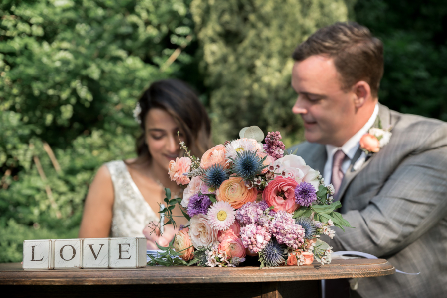 bouquet details as couple sign register by Adelaide elopement photographers Wilson and Lewis Photography