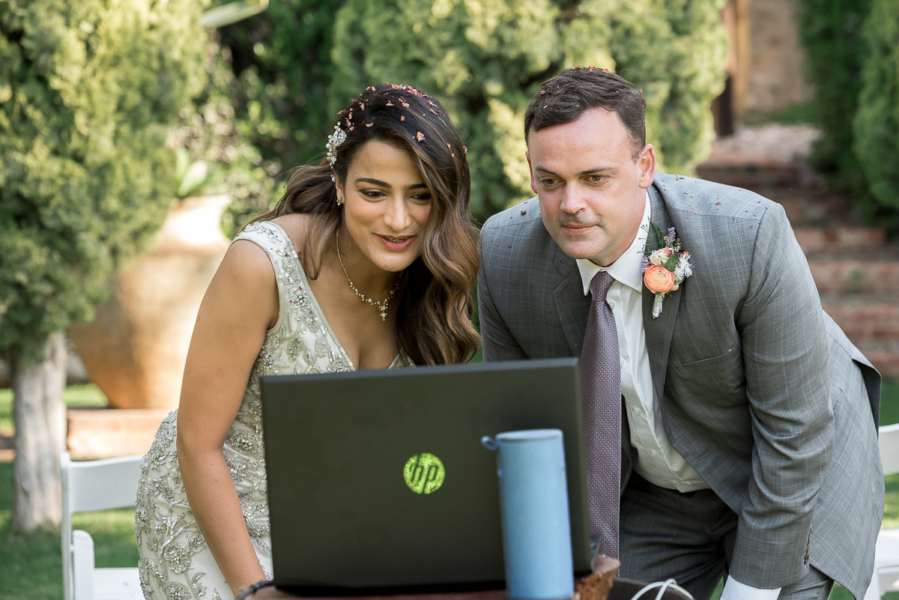 eloped couple say hello to guests on computer