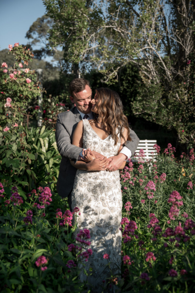 lover cuddle in flowers by delaide elopement photographers Wilson and Lewis Photography