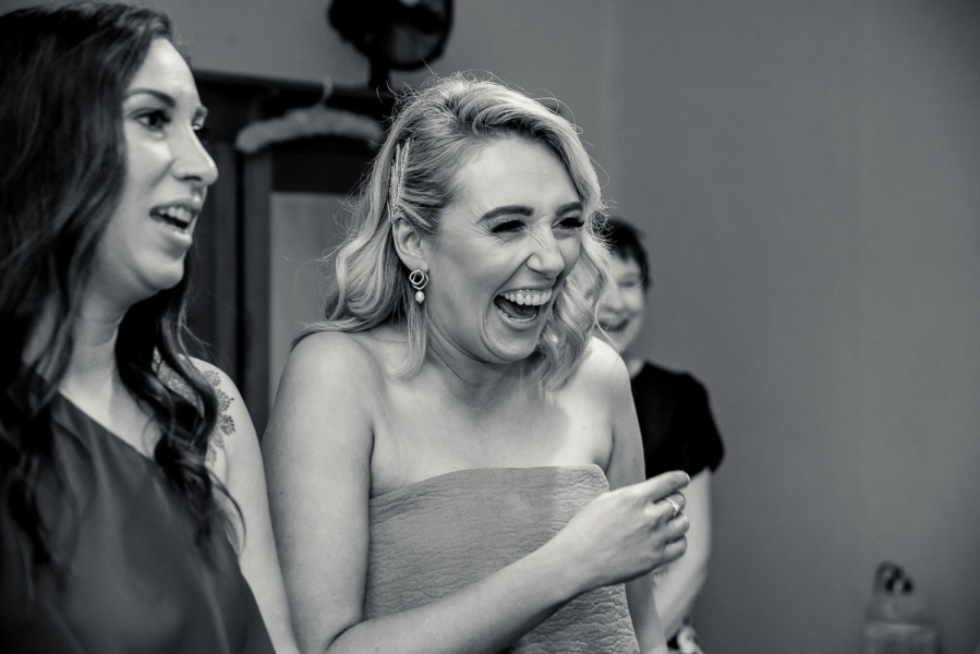 Bridesmaid laughing at wedding