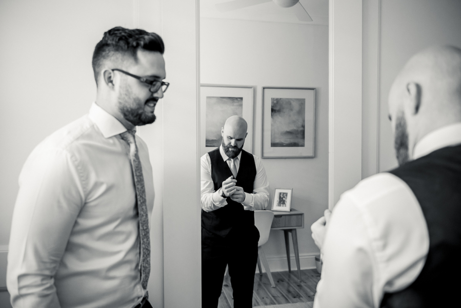 Best man and groom getting dressed