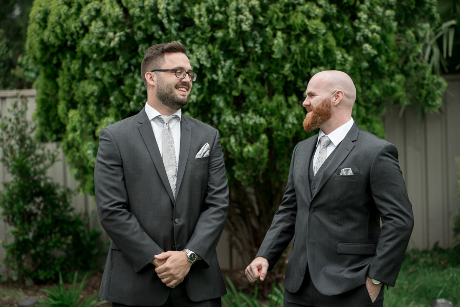 Groom and best man laughing in Mclaren Vale Garden